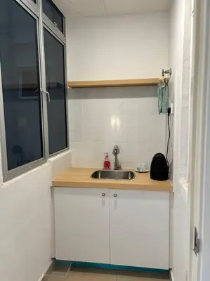a small kitchen with a sink and a window at KF Homestay Deluxe Suite in Kampar