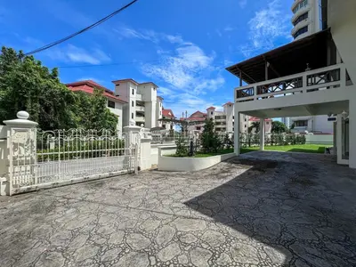 a white fence in front of a building at PRIME Location - 5 Mins Walk to Shops & Eateries! in Tanjung Bungah