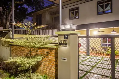 a parking meter in front of a house at night at Plumeria 4BR Garden House by uBook in Butterworth