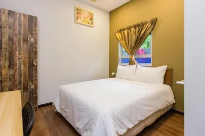a bedroom with a white bed and a window at Heaven 5BR Garden Inn by uBook in Butterworth