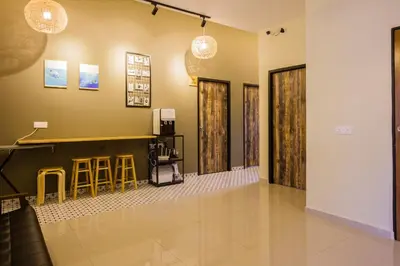 a lobby with a bar and some stools at Great 5BR Garden Inn by uBook in Butterworth