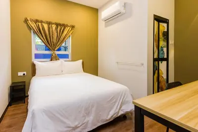 a bedroom with a white bed and a window at Great 5BR Garden Inn by uBook in Butterworth