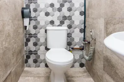 a bathroom with a toilet and a sink at Great 5BR Garden Inn by uBook in Butterworth