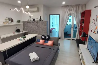 a living room with a couch and a tv at Purrfect Nook 1BR Georgetown Straits Garden \u4e00\u623f\u4e00\u5385\u5f0f in Jelutong