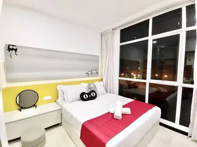 a bedroom with a bed with two dolls on it at Purrfect Nook 1BR Georgetown Straits Garden \u4e00\u623f\u4e00\u5385\u5f0f in Jelutong