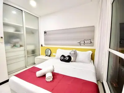 a bedroom with two stuffed animals sitting on a bed at Purrfect Nook 1BR Georgetown Straits Garden \u4e00\u623f\u4e00\u5385\u5f0f in Jelutong