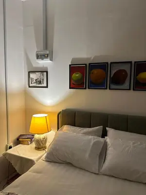 a bedroom with a bed with paintings on the wall at Husna homestay in Sungai Besar