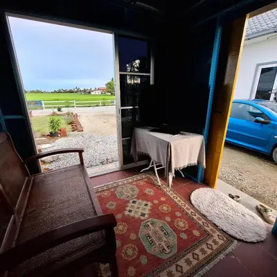 a room with a table and a chair and a window at Husna homestay in Sungai Besar