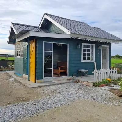 a blue tiny house with a porch at Husna homestay in Sungai Besar