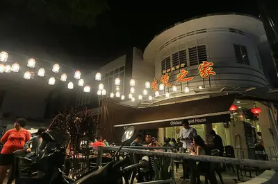 a group of people sitting outside of a restaurant at night at Navy Studio at Tropicana 218 at Central Location & Food Hunt Friendly in George Town