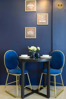 a table with two chairs and a blue wall at Navy Studio at Tropicana 218 at Central Location & Food Hunt Friendly in George Town