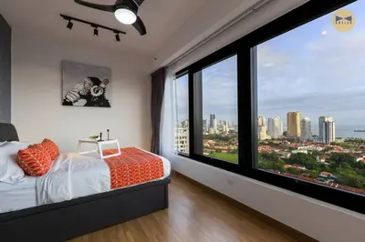 a bedroom with a large window with a view of a city at Seaview Sunrise 1BR at Tropicana 218 at Central Location & Food Hunt Friendly in George Town