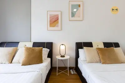 two beds sitting next to each other in a room at Spacious 3BR in Tropicana 218 at Central Location & Food Hunt Friendly in George Town