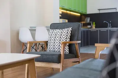 a chair with a pillow on it in a kitchen at Landed 3BR Home Near Beach, Seafood & Fisherman Village in Bayan Lepas