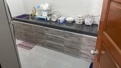 a kitchen with a counter with dishes on it at Homestay Cactus Apparment in Brinchang