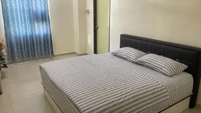 a bed with two pillows on it in a bedroom at Homestay Cactus Apparment in Brinchang