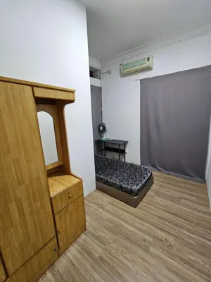 a room with a bed and a mirror in it at Amoy Lane Hostel Penang in George Town