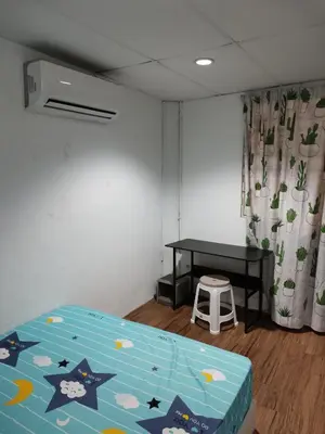 a bedroom with a bed and a table and a stool at Amoy Lane Hostel Penang in George Town