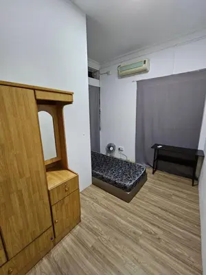 a room with a bed in the corner of a room at Amoy Lane Hostel Penang in George Town