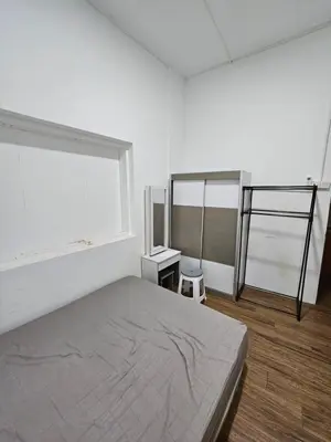 a white bedroom with a bed and a window at Amoy Lane Hostel Penang in George Town