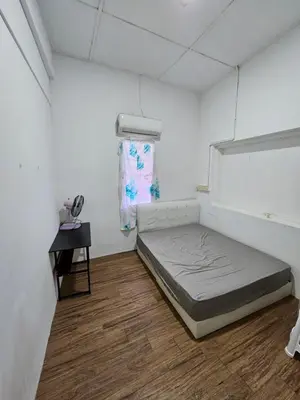 a white room with a bed and a table at Amoy Lane Hostel Penang in George Town