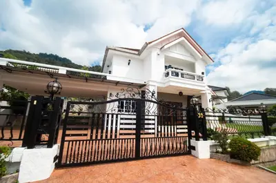 a white house with a black gate at Bukit Mertajam Double Storey Bungalow 15pax BBQ KTV in Bukit Mertajam