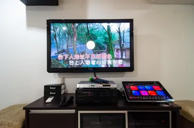 a flat screen tv sitting on top of a table at Bukit Mertajam Double Storey Bungalow 15pax BBQ KTV in Bukit Mertajam