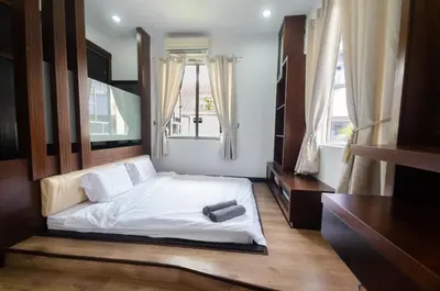 a bedroom with a white bed and two windows at Bukit Mertajam Double Storey Bungalow 15pax BBQ KTV in Bukit Mertajam