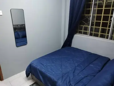 a bedroom with a blue bed and a window at Amara Homestay Cameron Highlands in Cameron Highlands