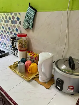 a kitchen counter with a counter top with a toaster at Homestay Cikgu Siti teluk intan in Teluk Intan