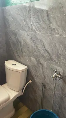 a bathroom with a white toilet in a room at Homestay Cikgu Siti teluk intan in Teluk Intan