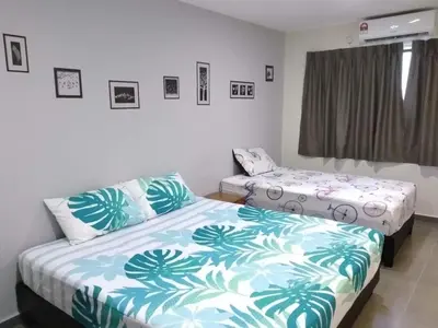 a bedroom with two beds and a window at Ipoh Budget in Ipoh