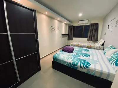 a bedroom with two beds and a closet at Ipoh Budget in Ipoh