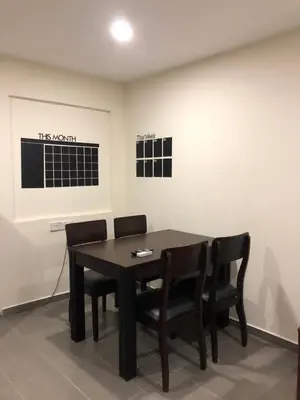 a dining room with a black table and chairs at Ipoh Budget in Ipoh