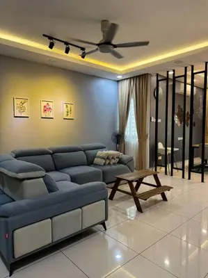 a living room with a blue couch and a table at Stylaa Homestay Bertam in Kepala Batas