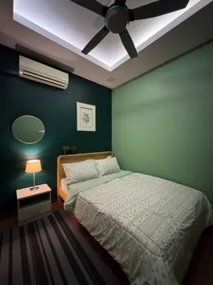 a green bedroom with a bed and a ceiling fan at Stylaa Homestay Bertam in Kepala Batas