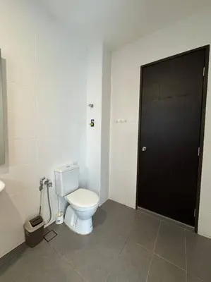 a bathroom with a toilet and a black door at Stylaa Homestay Bertam in Kepala Batas