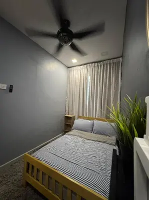 a bedroom with a bed with a ceiling fan at Stylaa Homestay Bertam in Kepala Batas