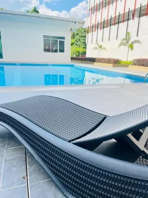 a swimming pool with a bench in front of a building at Anderson Ipoh by Iconique Espace in Ipoh