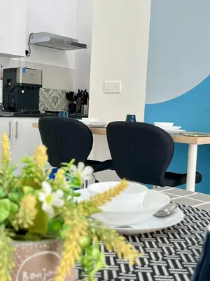 a table with chairs and a table with a plate at Anderson Ipoh by Iconique Espace in Ipoh