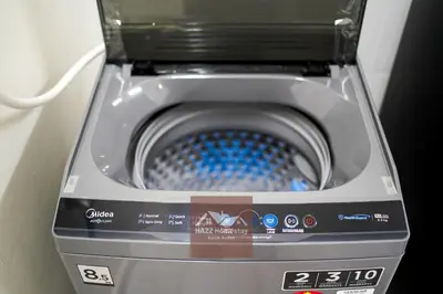 a washing machine with a blue inside of it at HAZZ Homestay Kulim IV in Kulim