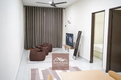 a living room with a couch and a bed at HAZZ Homestay Kulim IV in Kulim