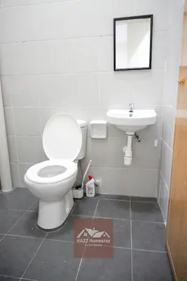 a bathroom with a toilet and a sink at HAZZ Homestay Kulim IV in Kulim