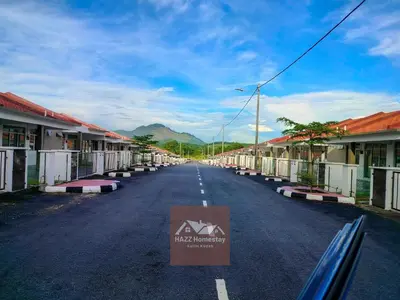 a street in a village with a house sign on the road at HAZZ Homestay Kulim IV in Kulim