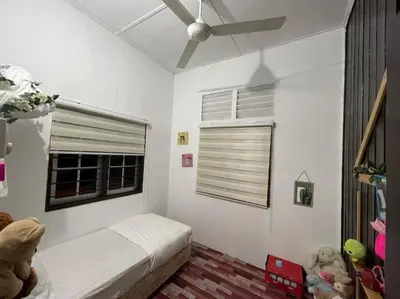 a bedroom with a bed and a window with a ceiling fan at Anggerik Homestay suasana kampung in Kampong Batu Dua Puloh Tiga