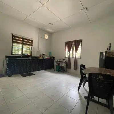 an empty room with a table and a table and chairs at Anggerik Homestay suasana kampung in Kampong Batu Dua Puloh Tiga