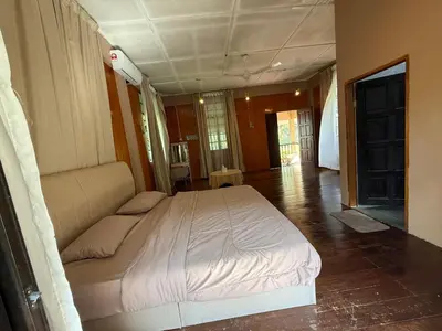 a bedroom with a large bed in a room at Villa Kuala Woh Resort in Tapah