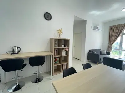 a living room with a table and chairs at Ipoh Town Centre The Anderson For 5pax in Ipoh