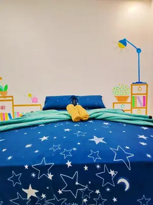 a bedroom with a blue bed with stars on it at GOLDEN HOUSE ,1min to aeon, 7min to zoo,8min to lake gardens in Taiping