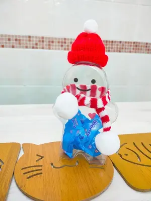 a plastic snowman in a red hat holding a star at GOLDEN HOUSE ,1min to aeon, 7min to zoo,8min to lake gardens in Taiping